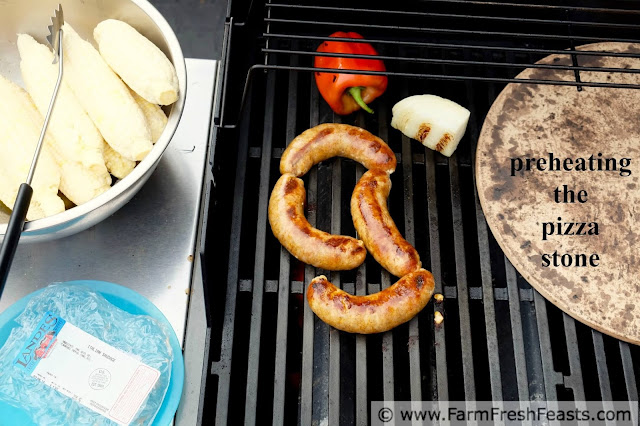 grilling the toppings and preheating the grill stone to make grilled sausage and peppers pizza