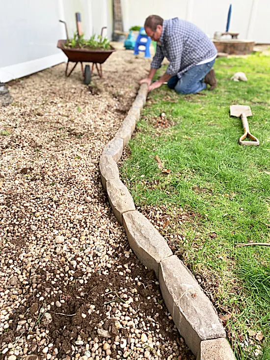 man laying blocks in a row