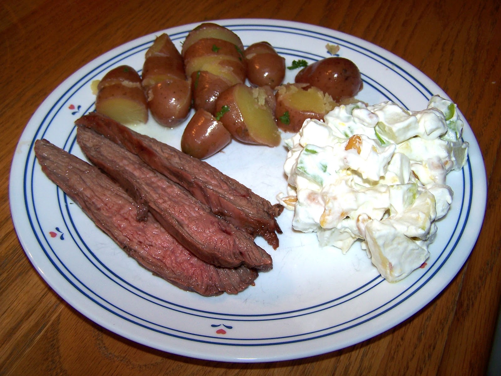 Flank steak, buttered red potatoes and taffy apple salad
