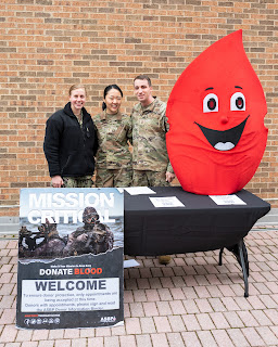 Stainiger's blood donation booth, alongside ENS Amy Pearson (left) and 2nd Lt. Elizabeth Kwon (middle). (Photo courtesy of 2nd Lt. Adam Stainiger)