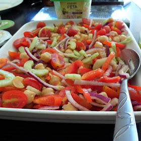Greek Salad:  A fresh and delicious salad with tomatoes, cucumber, red onion, red bell pepper, and garbanzo beans tossed in a lemon and oregano dressing. 