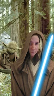 Image with my face inserted into a Jedi costume with a light saber.