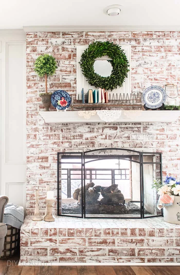 chalk painted brick fireplace decorated with patriotic cottage charm