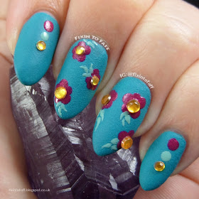 What I Did Wednesday plum drop dot flowers nail art over teal textured swatch with yellow rhinestone accents.