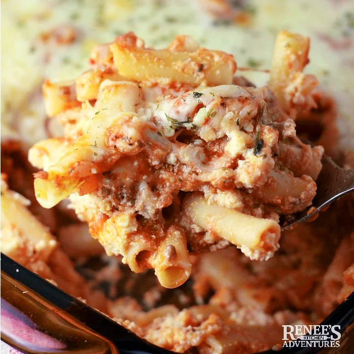Baked ziti with sausage on a spoon ready to serve