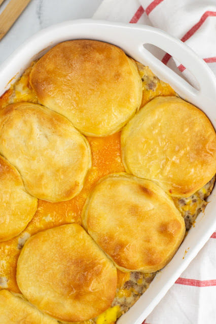 casserole in a white baking dish with red and white striped towel on the side.