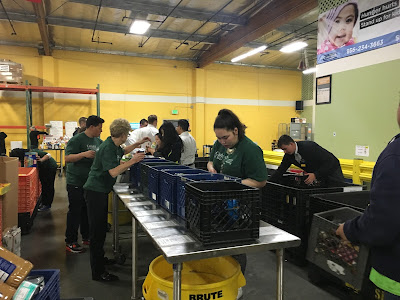 Campus community help sort 6,000 pounds of food that will be distributed to families throughout the Peninsula