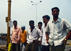 Group of men waiting to cross the road