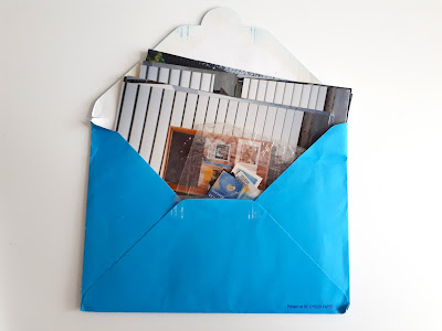 Opened envelope showing pictures of notice board with book jackets pinned to them.