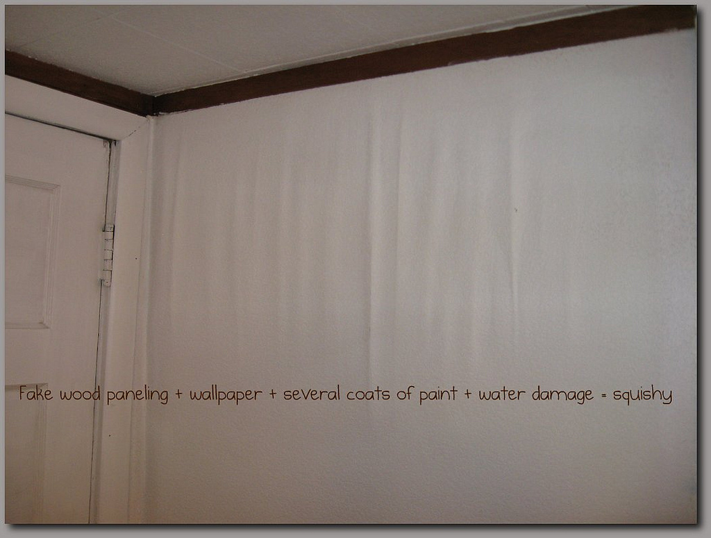 Caption says: Fake wood paneling + wall paper + several coats of paint ...