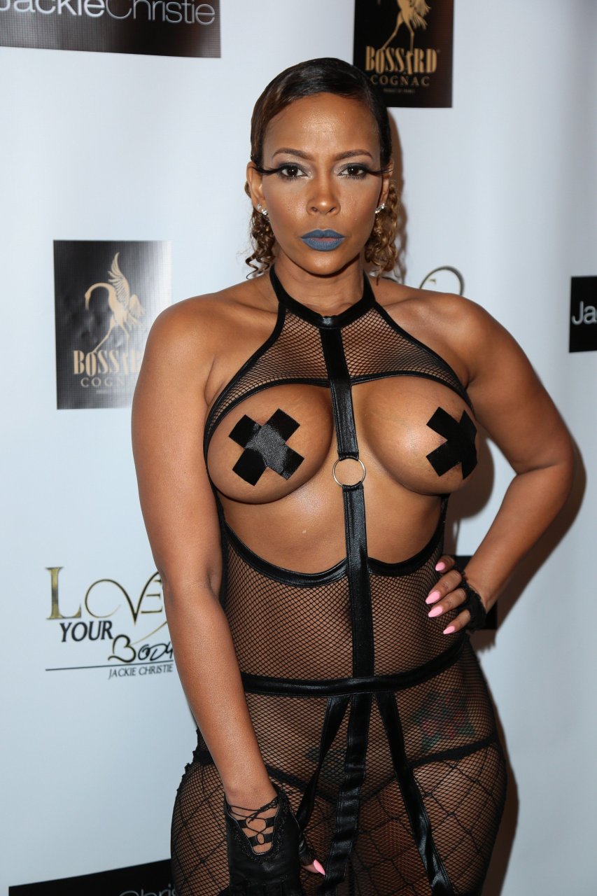 Sundy Carter wears extremely risque dominatrix dress that flashes cleavage and bare ASS