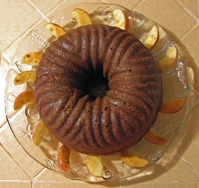 Whole Apple Cake on Cake Plate Surrounded by Apple Slices