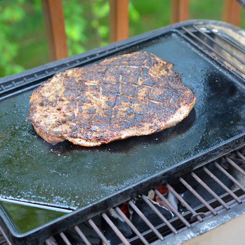 Griddle cooked flank steak on the PK Grill