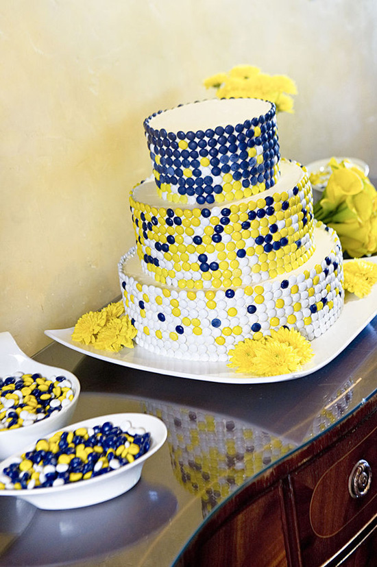 Great round wedding cake set over three tiers decorated with blue yellow 