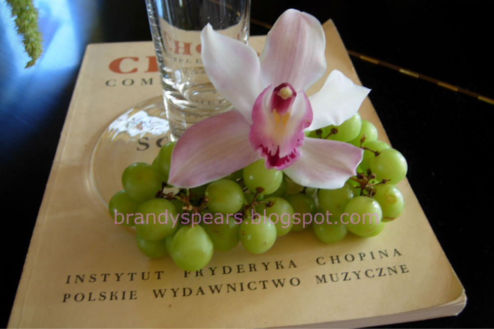 tall wedding centerpiece in pink hydrangea with grapes orchids and roses