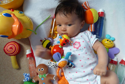 Baby on mat with lots of toys