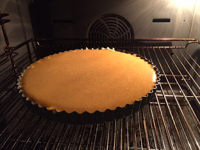 pumpkin pie in the oven ready to cook