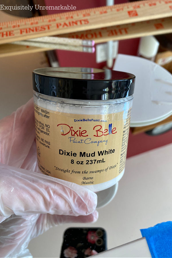 Dixie Belle White Mud Container in hand