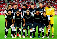 MÁLAGA C. F. - Málaga, España - Temporada 2012-13 - OLYMPIAKOS 3 (Mitroglou 2 y Manolas),  MÁLAGA C.F 3 (Papazoglou (p.p.), Eliseu y Seba Fernández) - 07/08/2012 - Partido amistoso - Atenas (Grecia), estadio de Giorgos Karaiskakis - Alineación: Kameni; Sergio Sánchez, Demichelis (Jesús Gámez, 46'), Weligton, Eliseu; Isco (Portillo, 79'), Camacho, Toulalan, Duda (Joaquín, 64'); Buonanotte (Monreal, 85') y Juanmi (Seba Fernández, 64')