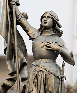 status of joan of arc holding her banners