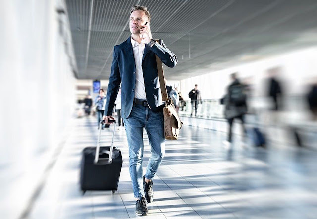  Young Businessman Walking In An Airport Terminal