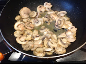 mushrooms sauteing in a skillet
