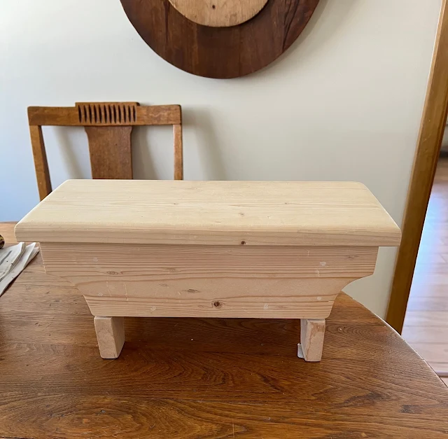 Photo of Goodwill wooden hinged mini stool.