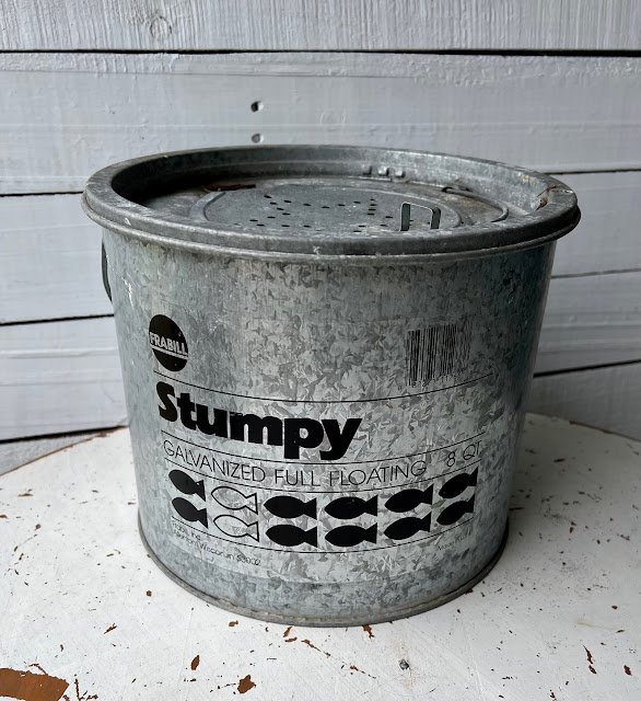 Photo of a metal minnow bucket.