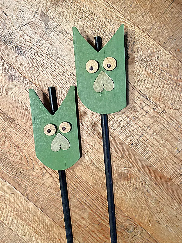 green owls on metal stakes