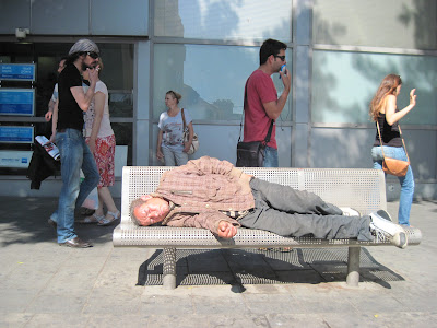 Homeless sleeping on a bench in Allenby street Tel Aviv at noon