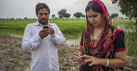 Farmers receive updates on climate smart practices on their phones, as part of an adaptation project in Karnal, India. (Credit: CCAFS/Prashanth Vishwanathan) Click to Enlarge.