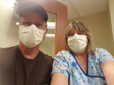 Jimmy and wife Cindy both wearing a surgical mask during a visit to hospital emergency room.