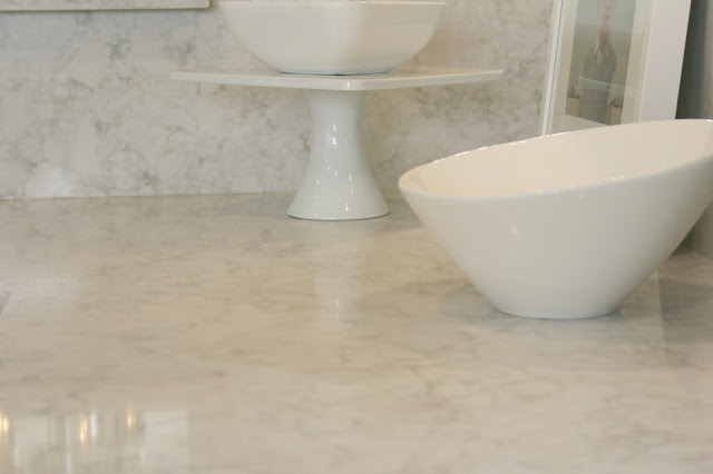 Serene chic simple Nordic French kitchen with grey cabinets and Soprano quartz countertop and backsplash