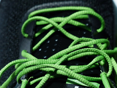 Picture of sneaker with green shoelaces