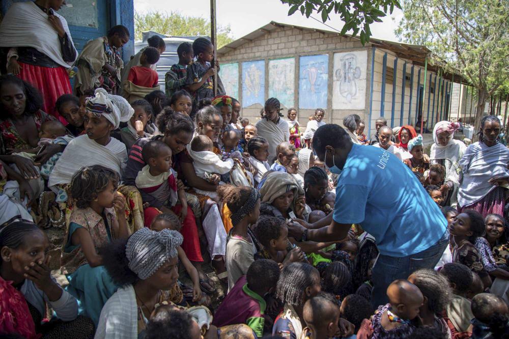 UNICEF Nutrition Specialist Joseph Senesie screens children for malnutrition in Adikeh, in the Wajirat district of the Tigray region of northern Ethiopia Monday, July 19, 2021. For months, the United Nations has warned of famine in Tigray and now internal documents and witness accounts reveal the first starvation deaths since Ethiopia's government in June imposed what the U.N. calls "a de facto humanitarian aid blockade." (Christine Nesbitt/UNICEF via AP)