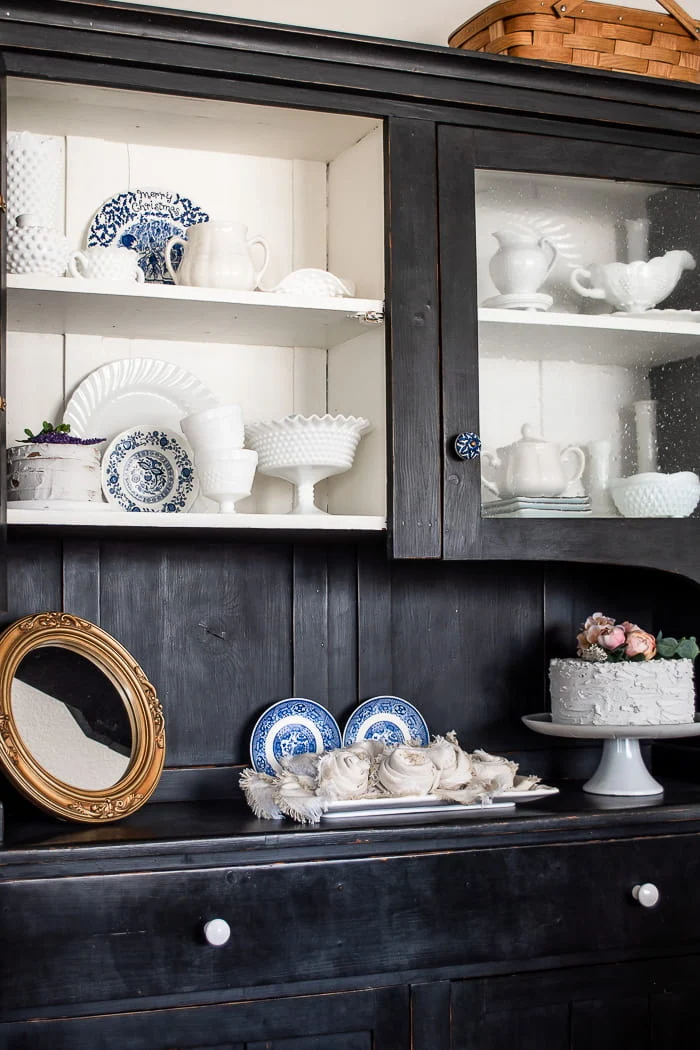 black hutch with white dishes