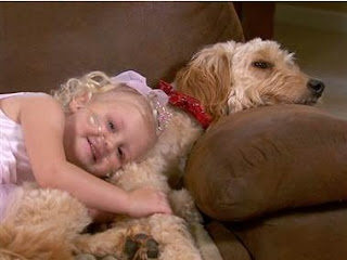 A Baby Sleeping With Her Puppies