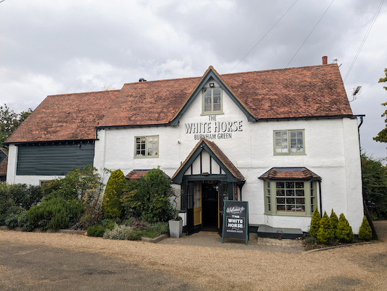 Walk past the White Horse on your left