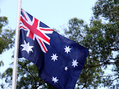 australian flag - photo of an australian flag waving in the breeze on a flag pole