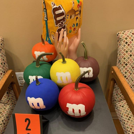Several  pumpkins decorated as M&Ms