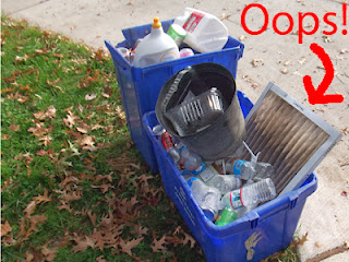 Furnace filter in blue recycling bin set out for collection