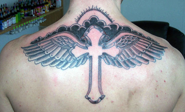  The gorgeous cross tattoo with wings and clouds and sun rays black and grey ink work tattoo designs