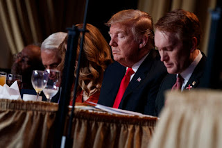 President Trump prays during the National Prayer Breakfast on Feb. 7 in Washington. The prayer breakfast is hosted by a group called the Family, which is portrayed in a new Netflix documentary. 