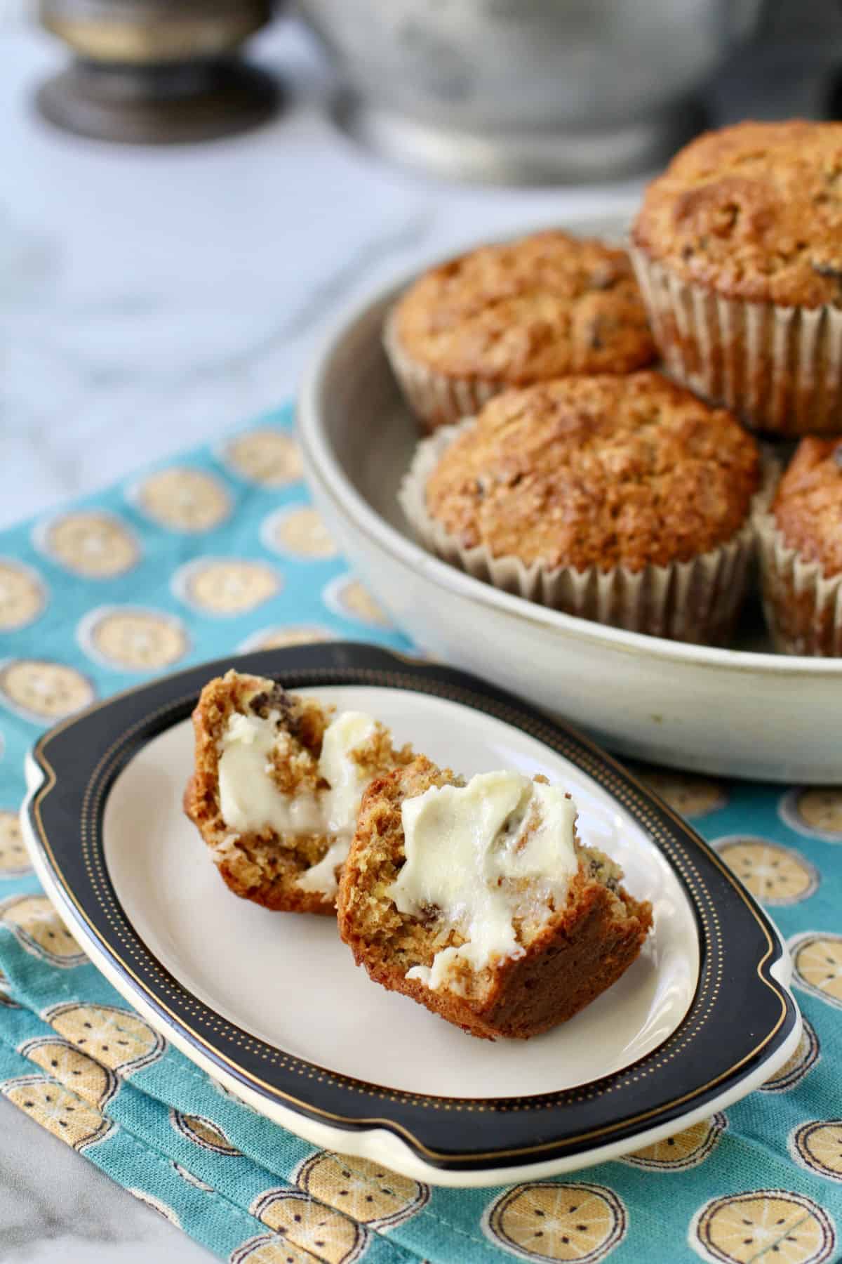 Raisin Bran Muffins spread with butter on a small plate.