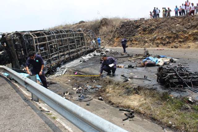 In this photo provided by the the newspaper Diario El Mundo de Orizaba, rescue personnel work at the scene of a deadly road accident between a bus and a semi-trailer, on a mountain road in Veracruz state, Mexico, Wednesday, May 29, 2019.