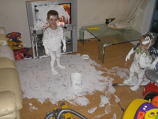 funny kids painting with house white paint making a major mess redecorating the living room and tv photo