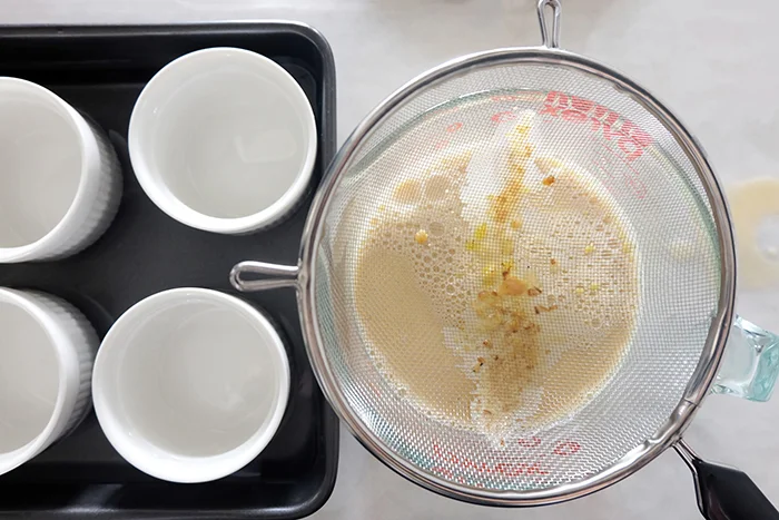 straining the custard base through a sieve