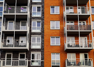 An exterior shot of brown and orange apartment units