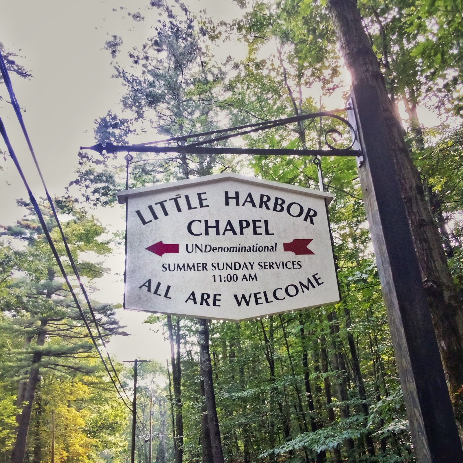 White Sign for Little Harbor Chapel White Sign for Little Harbor Chapel; white painted sign with golden letters reading Little Harbor Chapel UNdenominational Summer Sunday Services 11 am all are welcome