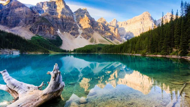 Free Blue Lake Surrounded by Mountains Beautiful Nature wallpaper. Click on the image above to download for HD, Widescreen, Ultra  HD desktop monitors, Android, Apple iPhone mobiles, tablets.